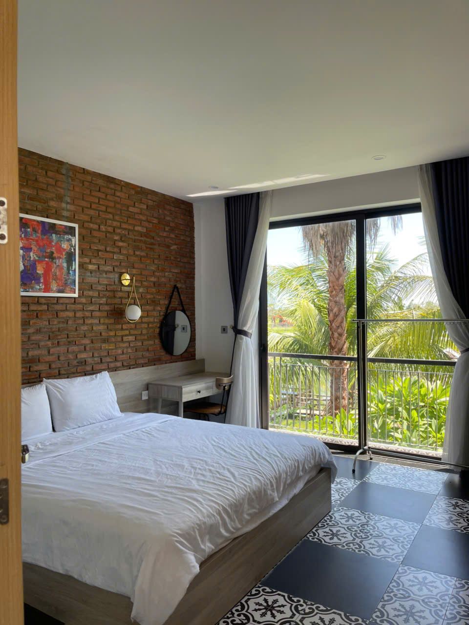 Bedroom with a big window onto palm trees