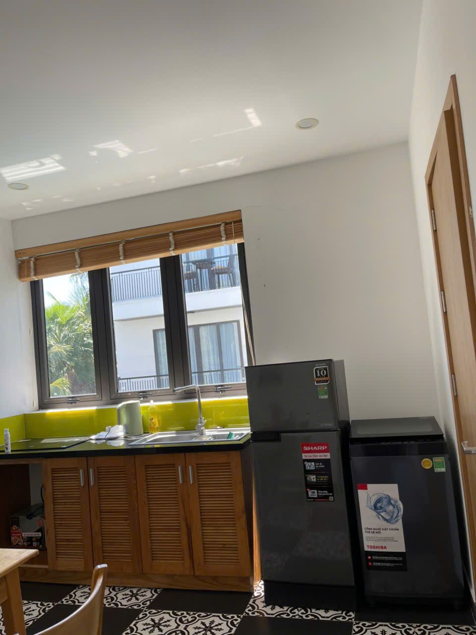 Small one-bedroom, Building B: Kitchenette with fridge and washing machine