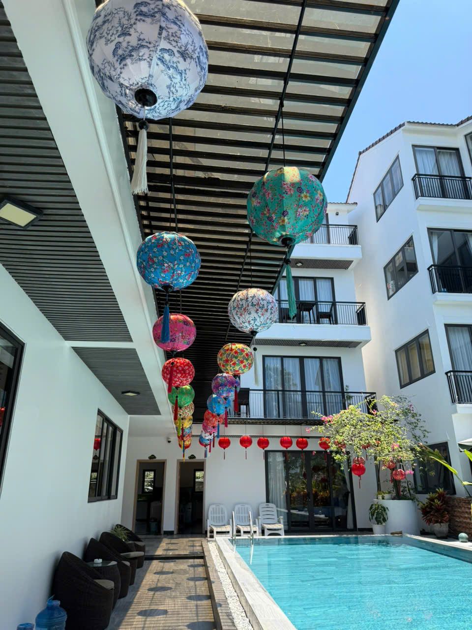 Lantern-lit walkway beside the pool